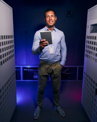 cheerful-data-center-employee-with-tablet-computer-e1714164550408