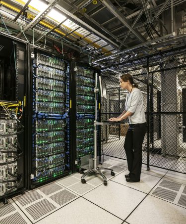 caucasian-woman-technician-working-on-computer-servers-in-a-server-farm-1-1-qo3zc9urk9c7a7nk42kwh8sehxftfpyi3m6eftyyr6