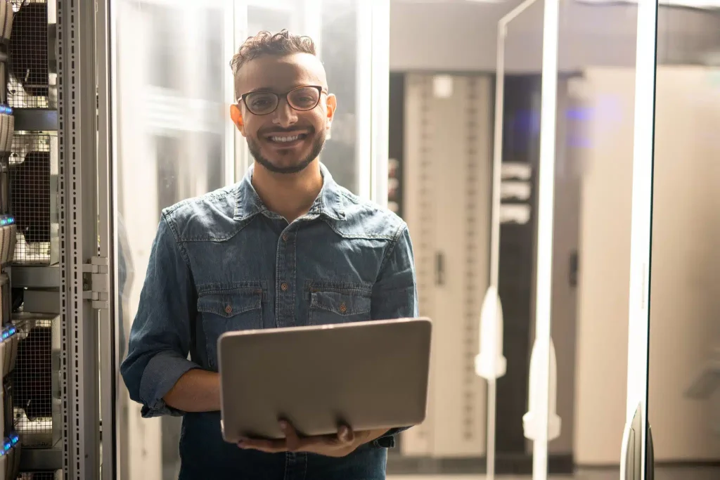 cheerful-server-engineer-in-datacenter-room-2023-11-27-05-03-24-utc-scaled