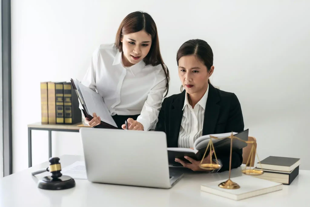 female-lawyer-is-holding-law-book-and-giving-advic-2023-11-27-05-01-20-utc-scaled