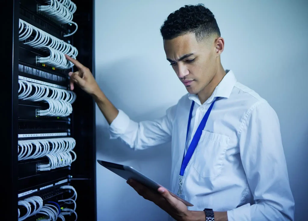 man-engineering-and-tablet-in-server-room-or-data-2023-11-27-05-14-51-utc-scaled