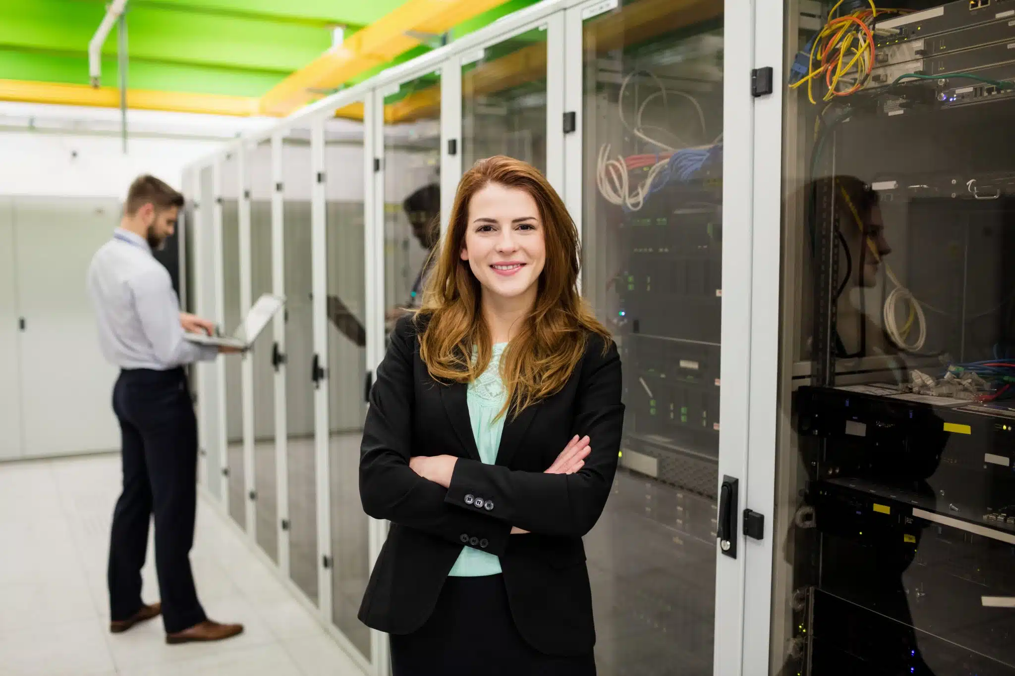 technician-standing-with-arms-crossed-in-a-server-2023-11-27-05-09-47-utc-scaled technician-standing-with-arms-crossed-in-a-server-2023-11-27-05-09-47-utc-scaled